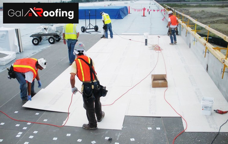 Roof membrane being installed on flat commercial roof